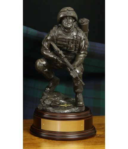 This is an 12" scale cold cast bronze sculpture of a Airborne Forces Combat Medic in an alert pose. We include this standard wooden base and choice of badge. We also offer an engraved brass plate as standard.