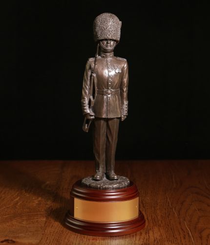 Cold Cast Bronze resin statue of a guardsman of the Grenadier Guards dressed in parade dress with bearskin and SLR. An engraved Brass plate is included
