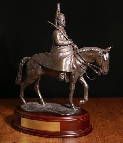 This is a cold cast bronze resin statue of a Blues and Royals Trooper mounted on horse back and dressed in Winter Review Order. We offer a range of wooden bases and engraved plates