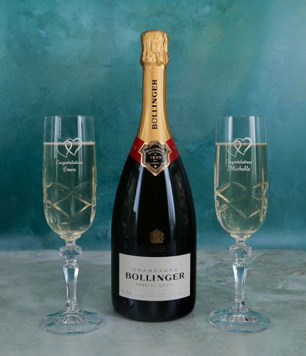 A standard 75cl Bottle of Bollinger Champagne and 2 Engraved Champagne Flutes in a Gift Box. The finished set is packed into a deep foam cutout presentation box. We agree the final engraving after you order. 