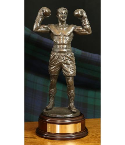 12" Scale cold cast bronze fine art sculpture of a modern boxer in a winning pose. It's the perfect presentation at any event or occasion involving boxing. As part of the standard service we can provide a fully engraved brass plate on the base.
