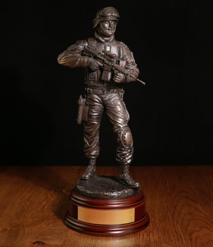 A Modern Armed British Police Officer with an issued H&K416 assault rifle. The sculpture is 12 Inches tall and we include the standard wooden base and an engraved brass plate as standard.