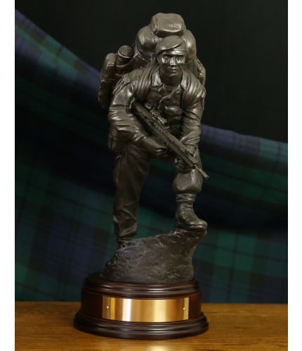 British Army Soldier in an alert pose. Sculpted at the 11" Scale he is equipped with an SA80 rifle, webbing and bergan.  A great leaving or military retirement gift. Included is an optional regimental crest in the base and an engraved brass plate