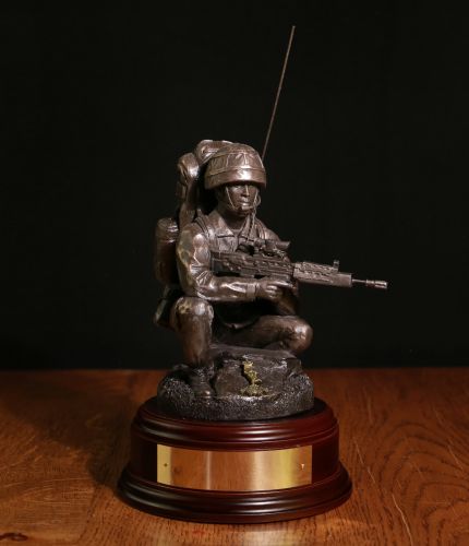 This is a British Army Signaller in a classic crouching position. We offer a choice of badge, wooden base and free engraving on the brass plate. The man standing would be 11" tall.