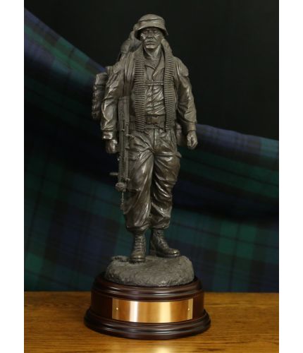 12" scale sculpture of a British Army Jungle Warfare soldier on patrol. We include this wooden base, a free badging service and an engraved brass plate as standard.