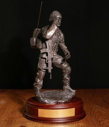 British Army "Contact" Signaller. This is a 12" scale statue of a modern combat front line signaller. We include this wooden base as standard, and you can also add a badge and engraving plate free of charge.