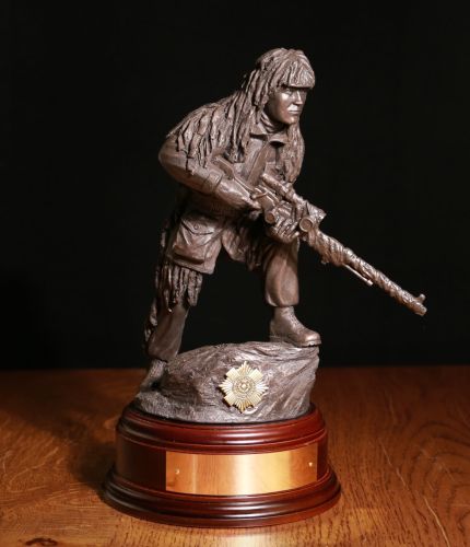 11" scale cold cast bronze resin sculpture of a British Army Sniper with  L96 rifle. We include a choice of wooden base as standard, and you can also add a badge and engraving plate free of charge.