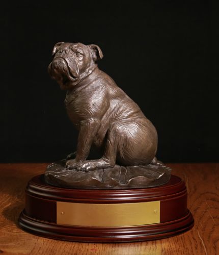 A Cold Cast Bronze British Bulldog sculpted in a 10" tall scale (on this wooden base) and sitting on a British Union Flag. We can make it in Bronze, Painted and Silver, the wooden base and a brass engraved plate are included.