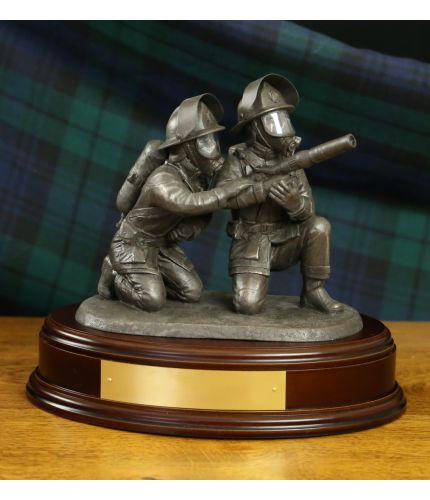 This Fire and Rescue statuette is called 'Laying Foam'. It depicts a pair of firefighters directing a high pressure jet of foam at the seat of a blaze. Our Bronze fire service sculptures make first class retirement. Wooden base and engraved plate included