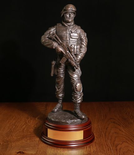 A Modern Armed British Police Officer with an issued G36 assault rifle. The sculpture is 12 Inches tall, we include the standard wooden base and an engraved brass plate as standard.