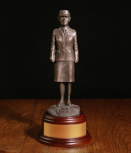 A Statuette of a modern female officer of the British Prison Service in parade dress. This one of our 8 inch scale statuettes and we include the wooden base and brass plate as standard.