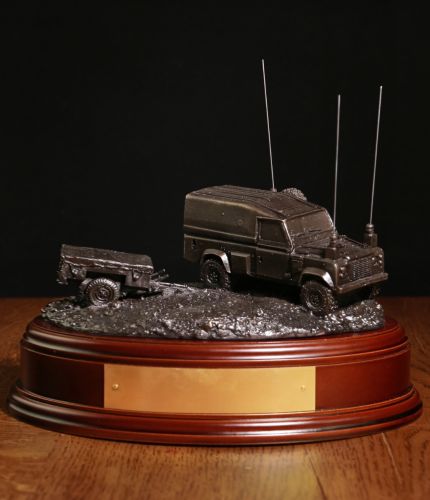 A scale model on a 3/4 Ton FFR Landrover and Trailer in cold cast Bronze Resin. We include this wooden base as standard and can add a cap badge to the base if required. We also offer a free brass plate engraving service.
