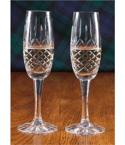 A pair of engraved crystal champagne flutes. We offer free engraving in the front panel of this item and the set is completed with a presentation box.
