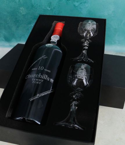 An engraved 75cl Bottle of Churchill's Special Reserve Port and two panel style crystal port glasses in a black foam cut out gift box. The Bottle and glasses can be engraved and we'll sort this out with you after ordering