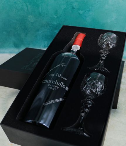 An engraved 75cl Bottle of Churchill's 10 Year Old Tawny Port and two fully cut crystal port glasses in a black foam cut out gift box. The Bottle can be engraved and we'll sort this out with you after ordering.