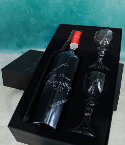 An engraved 75cl Bottle of Churchill's 10 Year Old Tawny Port and two plain style crystal port glasses in a black foam cut out gift box. The Bottle and glasses can be engraved and we'll sort this out with you after ordering.