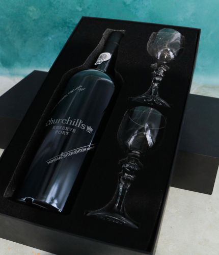 An engraved 75cl Bottle of Churchill's Special Reserve Port and two plain style crystal port glasses in a black foam cut out gift box. The Bottle and glasses can be engraved and we'll sort this out with you after ordering.