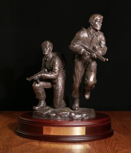 12" scale replica of the bronze life-sized sculpture in the Commando Training Centre. It depicts two WW2 Commandos storming forward showing real 'commando spirit'. We include an engraved brass plate.