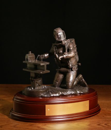 This is an 8" scale underwater diver on the seabed undertaking demolition work. We offer a choice of finishes and bases and if requested, we can add a brass plate and cap badge for you.