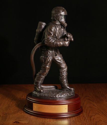 Male British Firefighter, The Branch with a personal engraved brass plate to make a great gift for a retiring fireman after years of service. We offer a choice of wooden bases and free engraving