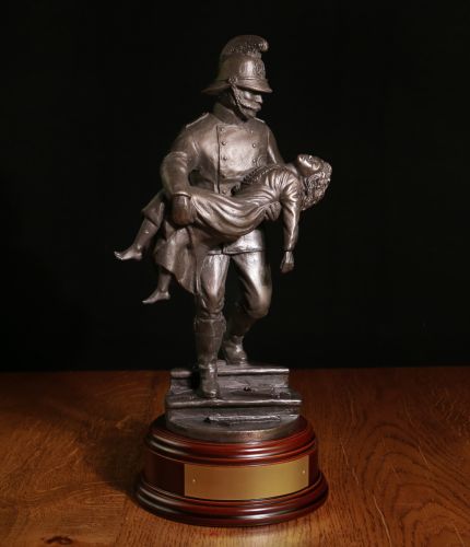 The classic 1981 Victorian 'Saved' Fireman with the first verse of the Fireman's Prayer on the back of the steps. Handmade in bronze cold cast resin. The engraved brass plate is included
