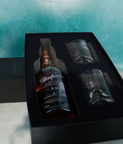 A fully engraved bottle of 12 Year old Glenfarclas Single Malt Scotch Whisky and two engraved 10oz crystal whisky tumblers. The set is presented in this black box with foam cutouts. Engraving sorted afterwards.