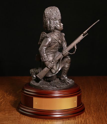 Bronze cold cast resin statuette of a soldier of the Gordon Highlanders kneeling in the trampled rye during the battle of Quatre Bras. We offer a choice of wooden base and a free engraved plate.