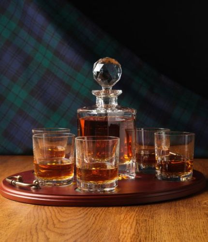 This is our very popular 7 piece panelled whisky serving tray set. It consists of a 24% lead crystal panel cut square decanter and six whisky tumblers on a serving tray with personalised hand engraving. All set up and engraving is included in the price.