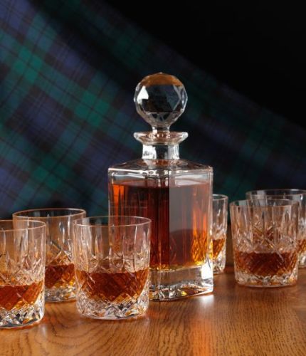 A fully cut  whisky crystal hosting set consisting of a Decanter and six tumblers. The set is completed inside two dark blue satin lined presentation boxes.