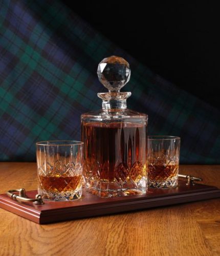 A 24% lead crystal fully cut square decanter and two fully cut whisky tumblers on a serving tray. We can offer a personalised brass plate on the wooden tray with this set.