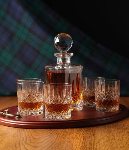 A 24% lead crystal fully cut square decanter and six fully cut whisky tumblers on a serving tray. We can offer a personalised brass plate on the wooden tray with this set.