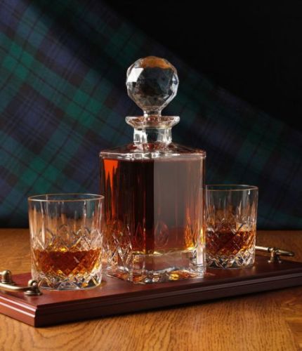 A mixed style of whisky crystal serving tray set consisting of a Decanter and two tumblers. We offer free engraving in the front panel of the decanter and a brass plate on the tray. The set is completed inside a dark blue satin lined presentation box.