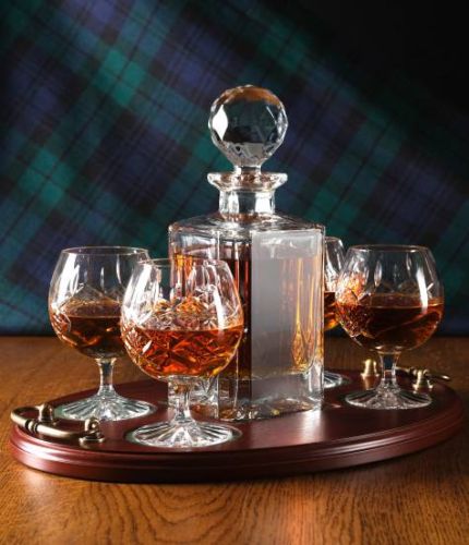 A 24% lead crystal panel cut square decanter and four panel cut brandy goblets on a serving tray. We can offer a personalised engraving on the front of the decanter, goblets and an engraved brass plate on the wooden tray with this set.