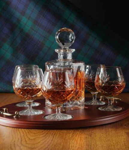 A 24% lead crystal fully cut square decanter and six brandy goblets on a serving tray. We can offer a personalised engraving on a engraved brass plate on the wooden tray with this set.