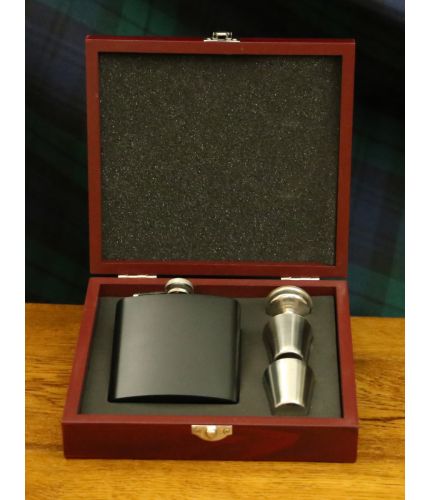 A matt black 6oz stainless steel hip flask with two thimble cups, filler funnel presented in its own lovely wooden box with cut-out foam inner. We include our full design and engraving service on the front of these items.