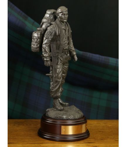 This is a modern British Army, he's 'The Knackered Tom'. We've made sure he's dressed in modern combat fatigues and is carrying his usual load of equipment and a belt of ammo for a GPMG. We offer a choice of bases and engraving is free.