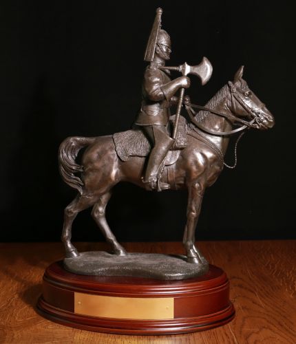 This is a 14" tall sculpture of a Life Guard Cavalry Regiment Farrier.  We mount for finished piece on its own wooden base and can add an engraved plate with the text of your choice.