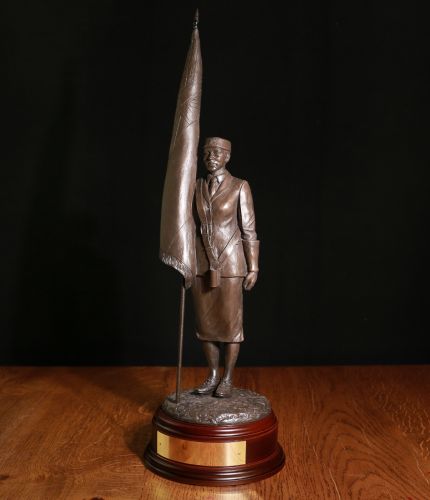 This is our 12" scale Female Standard Bearer Wearing a Hat. We can add your regimental cap badge to the base by her feet. We offer a choice of wooden bases and free engraving. 