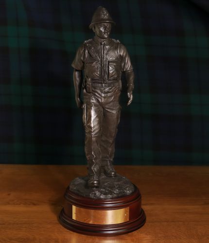 This presentation piece depicts a Modern British Police Constable on a daily foot patrol. The sculpture is 12 Inches tall and we offer a choice of wooden bases and an engraved brass plate as standard.