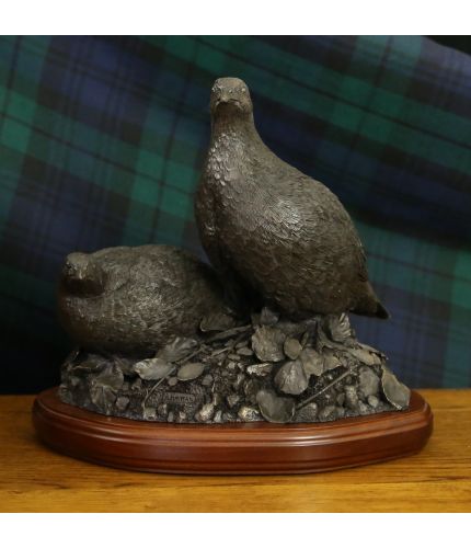 A cold cast bronze sculpture of a breeding pair of Partridges sculpted at full scale (12" tall, 11" side to side and 9" front to back).  Fine detail and a lovely shooting award, presentation or ornament. We offer a choice of wooden base.