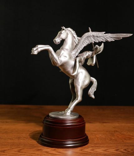 This pure pewter, hand buffed sculpture is of Pegasus and Bellerophon, the symbol of the British Airborne Forces. We offer the ornament with a choice of wooden bases and a free engraved nickel silver plate.