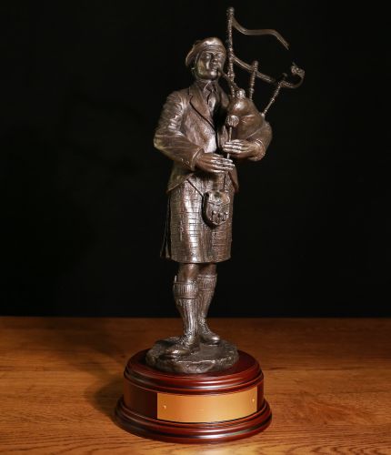 A Piobaireachd (Pibroch) Piper in cold cast bronze in a 12" scale. This is the perfect gift for any serious piper or perhaps to a chieftain at a Scottish Highland Gathering. We offer a choice of wooden bases and the engraved brass plate as standard.