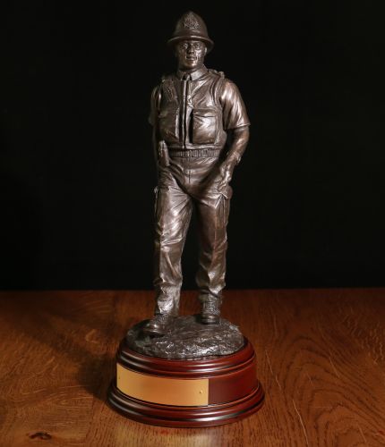 This presentation piece depicts a Modern British Police Constable on a daily foot patrol. The sculpture is 12 Inches tall and we offer a choice of wooden bases and an engraved brass plate as standard.