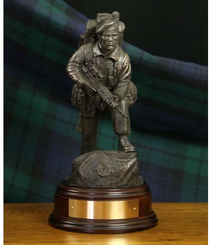 A Regimental Sculpture of a Royal Irish Regiment soldier fully equipped and dressed for a deployment anywhere in the world. Sculpted at the 11" Scale he is equipped with an SA80 rifle, webbing and bergan. There is a Royal Irish Regiment capbadge in the ba