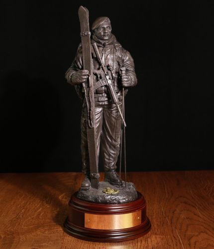 12" scale cold cast bronze sculpture with the help of 45 Commando of a Royal Marine dressed for arctic warfare in 2021. He is wearing webbing and a bergan with his C8 rifle slung across his chest. Engraving Plate included