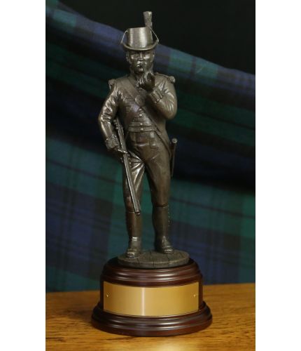 This 8" sculpture depicts a marine sharpshooter of 1805. We include the wooden base seen here as standard, and also offer a free engraved brass plate if requested.