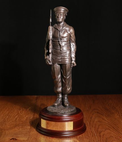 12" Scale sculpture of a Modern Day Royal Navy Rating on Parade with SA80 Rifle. The man is standing in the 'Attention' position. We offer various wooden base options and an engraving plate if required.