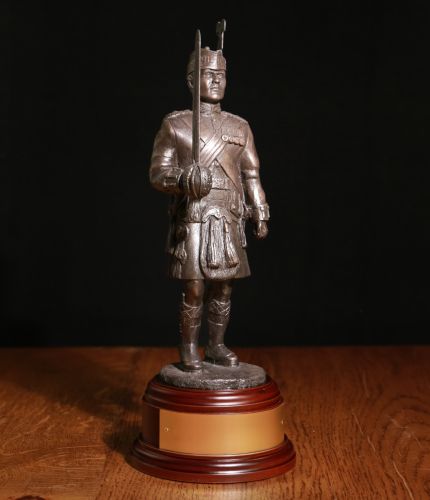 An Officer of the Royal Regiment of Scotland in Number 1 Dress with drawn Claymore. We offer a choice of wooden base and you can also add an engraving plate free of charge.