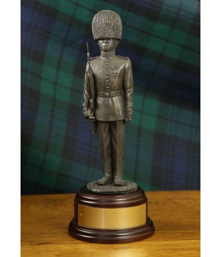 Bronze cold cast resin statuette of a Guardsman of The Scots Guards dressed in full parade dress with the distinctive red tunic and bearskin hat. He is armed the SLR rifle.