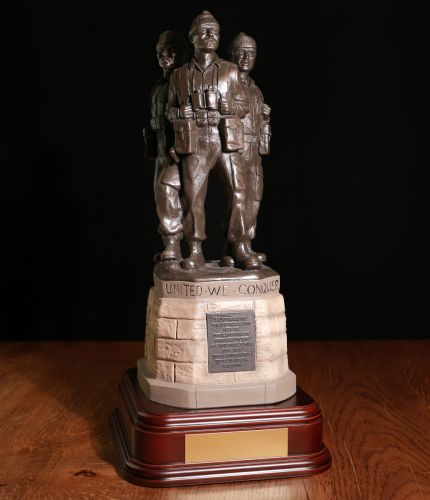 The Achnacarry Commando Memorial at Spean Bridge, the men on top are finished is bronze resin and the base is hand painted to match the full size monument. We include this standard wooden base (Mahogany is extra) and an engraved brass plate
